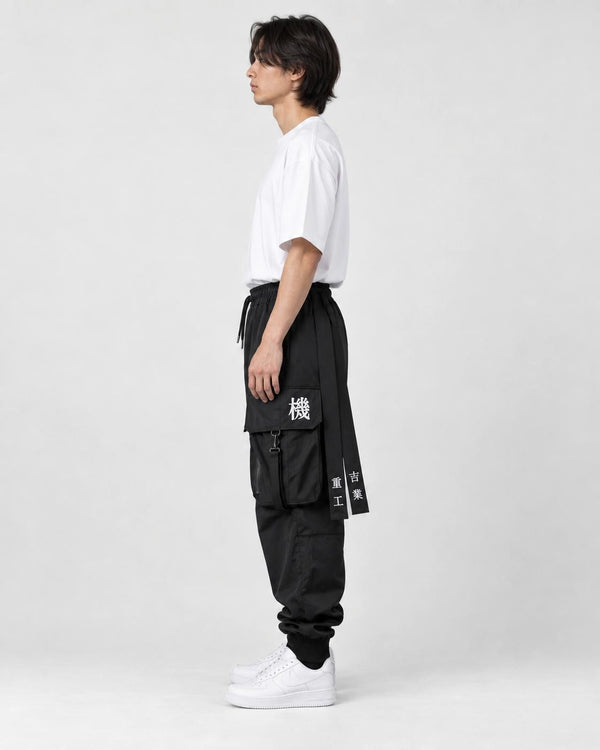 Model wearing the black cargo joggers, side view of the lettered hip straps