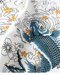 Close view of the blue-teal koi among white wave outlines and gold flowers on white cotton