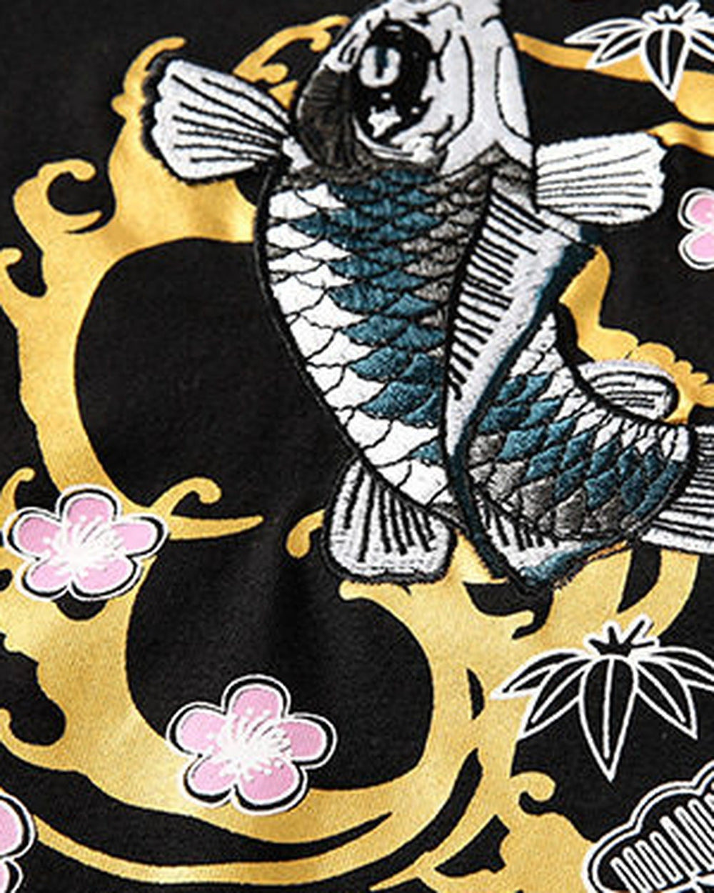 Close view of the koi inside the gold ring with pink plum blossoms and bamboo leaves on black cotton