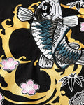 Close view of the koi inside the gold ring with pink plum blossoms and bamboo leaves on black cotton