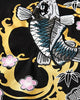 Close view of the koi inside the gold ring with pink plum blossoms and bamboo leaves on black cotton