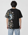 Man seen from behind in the black T-shirt with a koi, waves and plum blossoms down the left side of the back