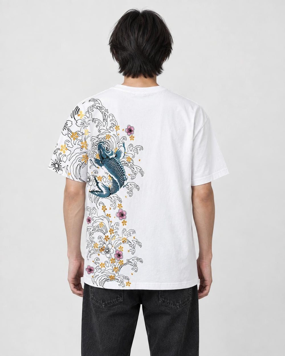 Man seen from behind in the white T-shirt with a koi, waves and plum blossoms down the left side of the back