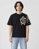 Man in the black T-shirt with a koi in a gold ring on the left chest and wave sleeve, jeans and white sneakers