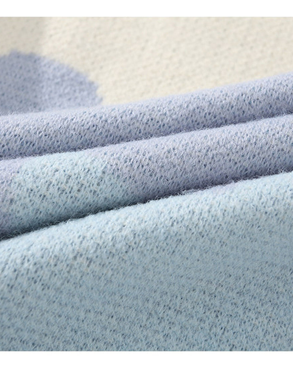Close-up of the knitted color blocks and sky blue rib