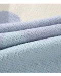 Close-up of the knitted color blocks and sky blue rib