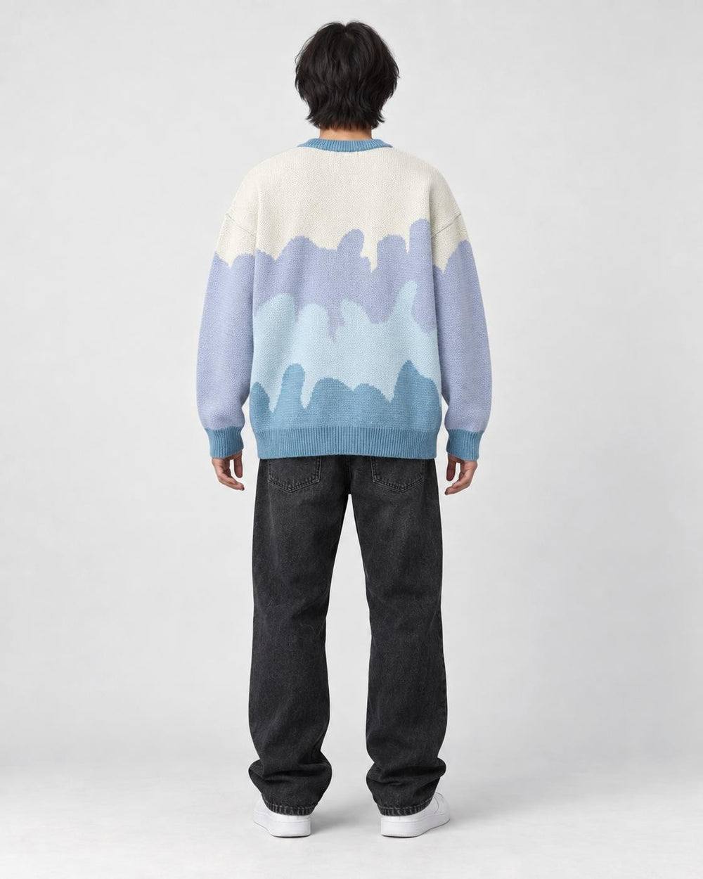 Model wearing the blue color block knit sweater, back view