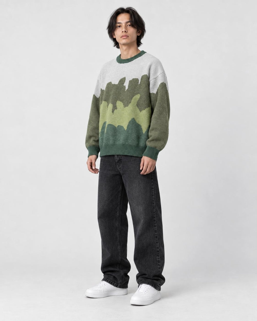 Model wearing the green color block knit sweater, three-quarter view