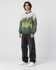 Model wearing the green color block knit sweater, three-quarter view