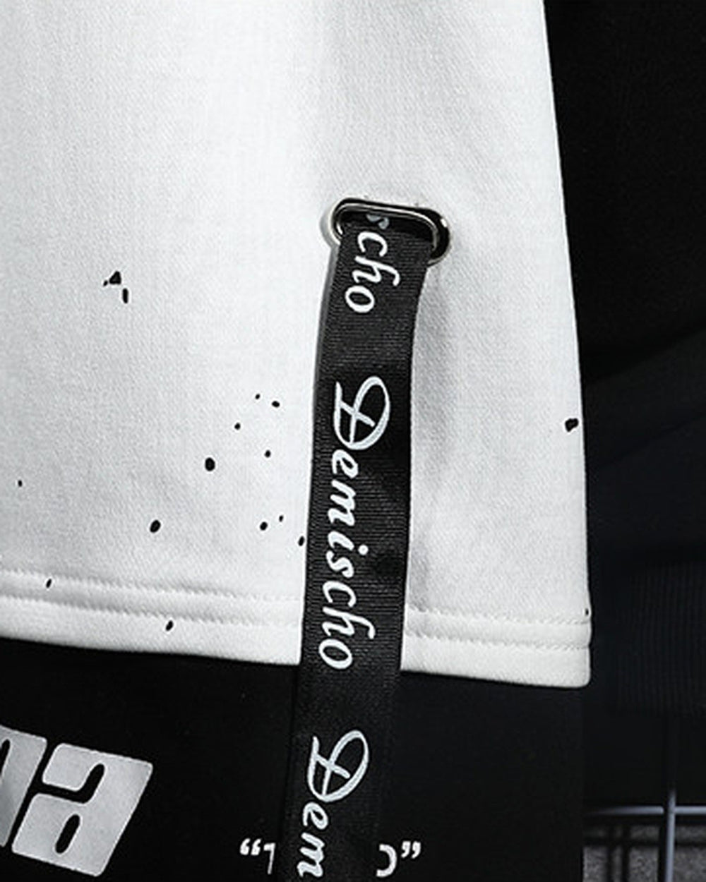 Close-up of the china lettering and ribbon straps on the hem
