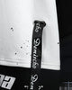 Close-up of the china lettering and ribbon straps on the hem
