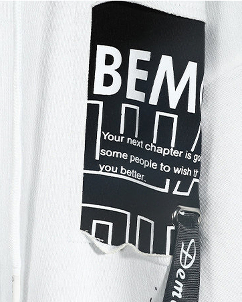 Close-up of the BEMC patch print and paint splatter on the white hoodie