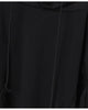 Close-up of the front of the black hoodie, with the drawcord, the layered sleeve panel and the angled seam