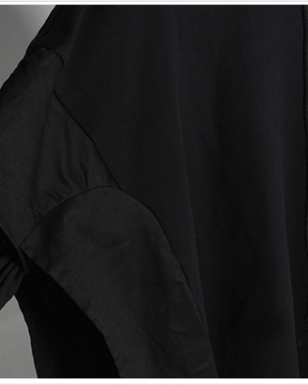Close-up of the cargo-pocket panel layered over the sleeve of the black hoodie