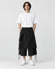 Model wearing the black layered wrap wide-leg pants with a white tee, front view