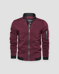 Burgundy bomber jacket with a black ribbed collar and a sleeve zip pocket, front view