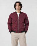 Model wearing the burgundy bomber jacket with stone trousers, front view