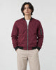 Model wearing the burgundy bomber jacket with stone trousers, front view