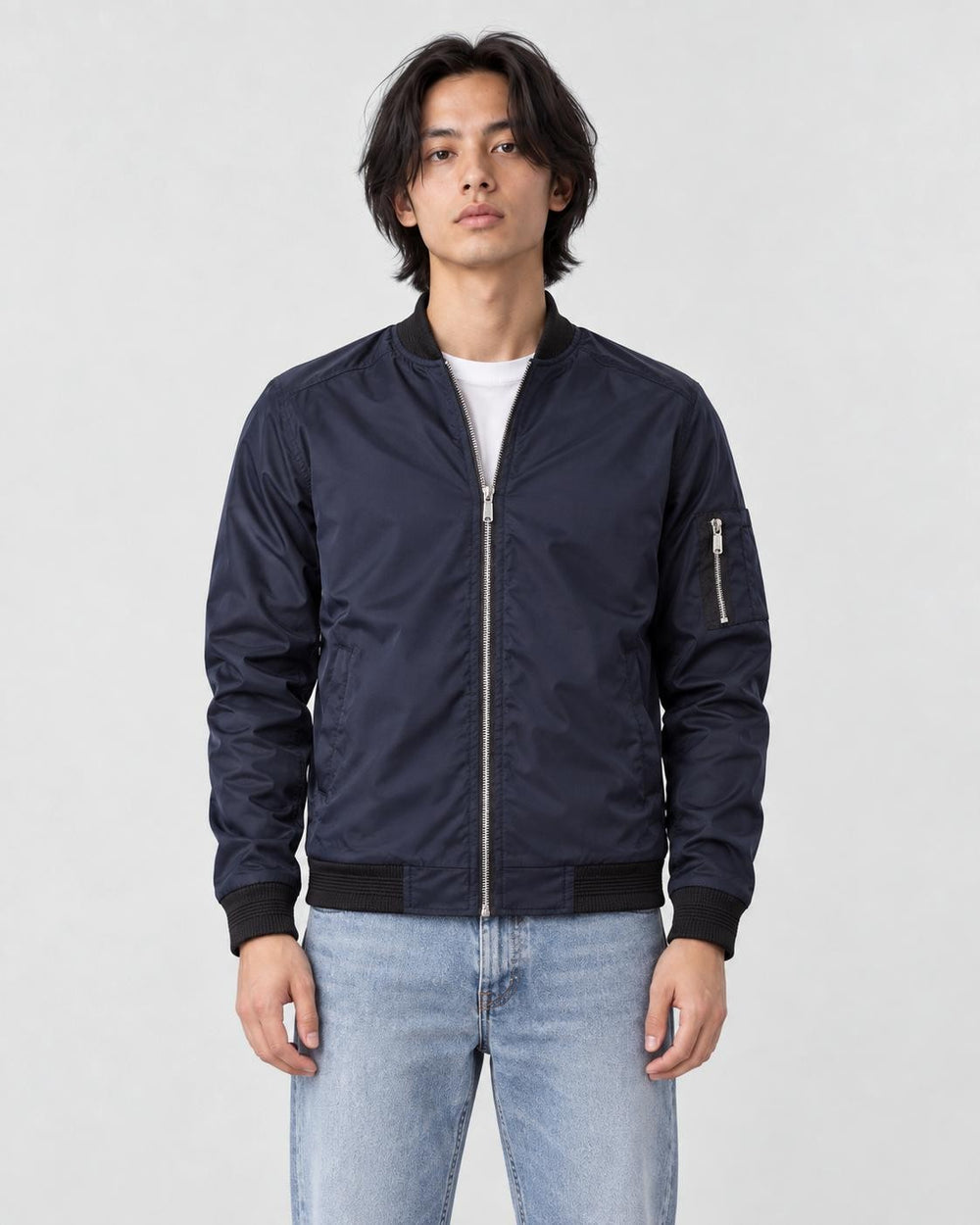 Model wearing the navy lightweight bomber jacket with a white tee, front view