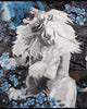 Close-up of the embroidered white lion with an open red mouth among blue blossoms