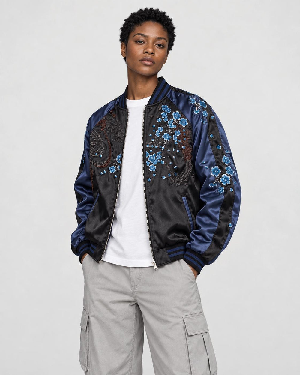 Model wearing the lion souvenir jacket open, three-quarter view