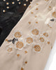 Close-up of cream and peach blossoms embroidered on the cream sleeve