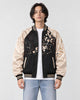 Model wearing the black and cream lion sukajan half zipped, front view
