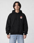 Model wearing the black hoodie with the small lion emblem on the chest, front view