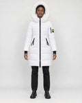 Model wearing the white long puffer coat with a white faux-fur hood, black jeans and black boots, front view