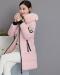Pink long puffer coat with a matching pink faux-fur collar, worn by a seated model