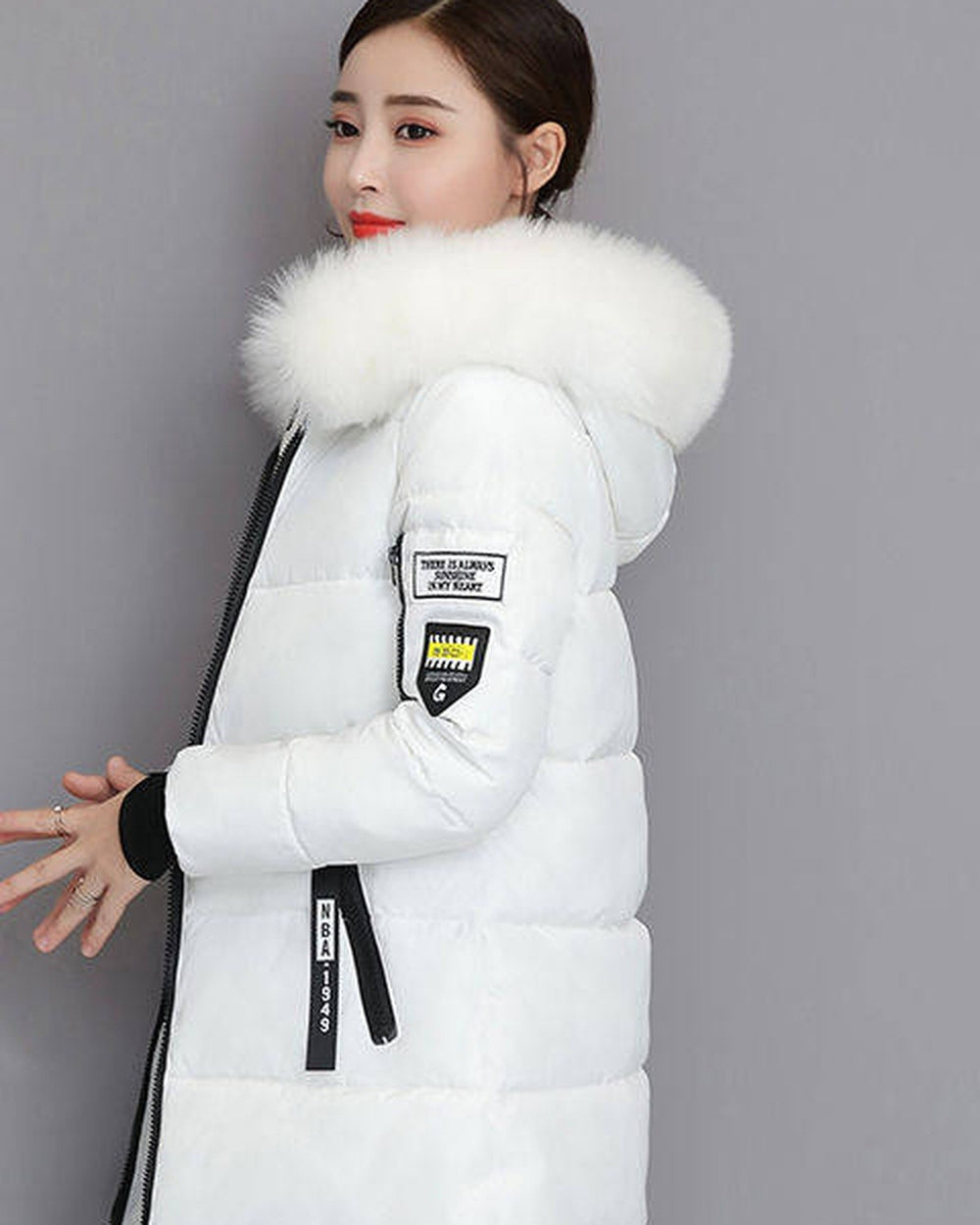 White long puffer coat with a white faux-fur collar, shown from the side and three-quarter on a model