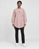 Model wearing the pink longline brushed pullover with slim black jeans, front view