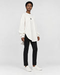 Model wearing the white longline brushed pullover, three-quarter view