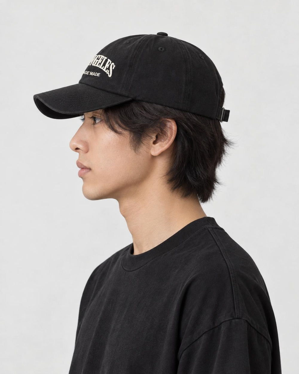 Model wearing the black Los Angeles dad cap, side profile