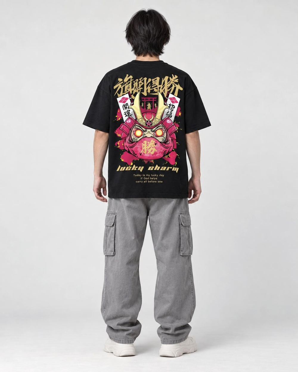 Model wearing the black daruma T-shirt, back view of the print