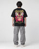 Model wearing the black daruma T-shirt, back view of the print