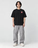 Model wearing the black daruma T-shirt with jeans, front view