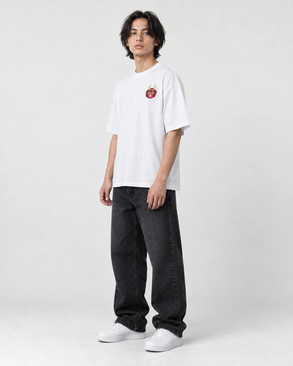 Model wearing the white daruma T-shirt, three-quarter view