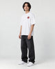 Model wearing the white daruma T-shirt, three-quarter view