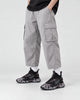 Model wearing the black marble print high-top sneakers with light gray cargo trousers, front view