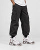 Model wearing the white marble print high-top sneakers with black cargo trousers, front view