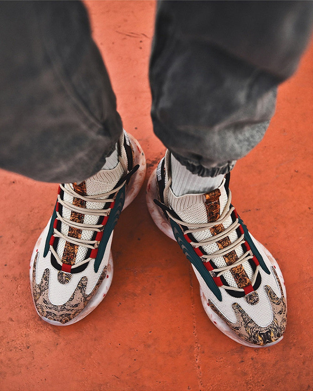 Beige marble print high-top sneakers worn on an orange floor, seen from above