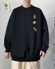 Black crewneck sweatshirt with an astronaut, a ringed planet and a rocket printed in a column on the left chest