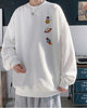 White crewneck sweatshirt with an astronaut, a ringed planet and a rocket printed in a column on the left chest