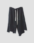 Black asymmetric panelled knee-length shorts with a cream drawcord, front view