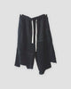 Black asymmetric panelled knee-length shorts with a cream drawcord, front view