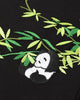 Close-up of the panda curled among green bamboo leaves embroidered on the black T-shirt