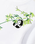 Close-up of the bamboo sprig and panda embroidered on the shoulder and chest of the white T-shirt