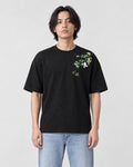 Model wearing the black bamboo and panda embroidered T-shirt with light jeans and white sneakers, front view