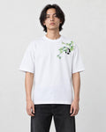 Model wearing the white bamboo and panda embroidered T-shirt with black jeans and white sneakers, front view